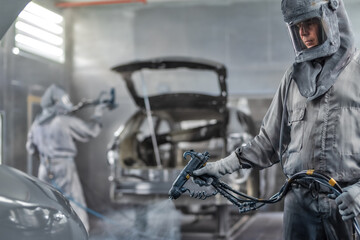 employee body painting workshop carries out painting of the internal elements of the car.