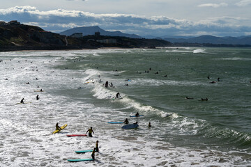 many surfers on the Plage de la Cote Basque Beach in Biarritz