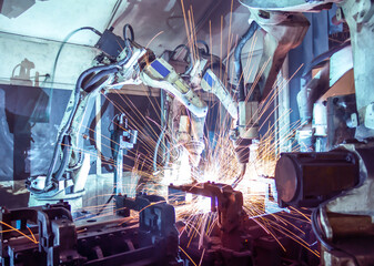 Robots welding in a car factory.