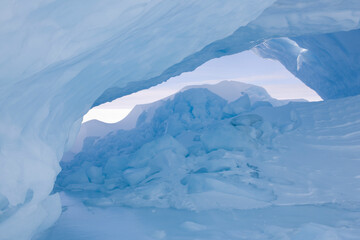 Antarctica inside a blue iceberg on a sunny winter day