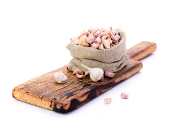 Garlic. Fresh garlic in a sack bag. Put on a wooden cutting board White background