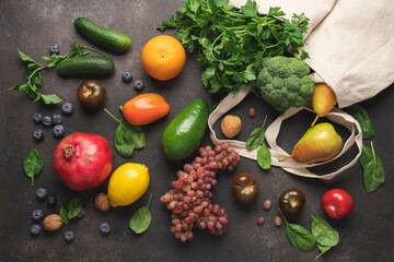 Vegetables and fruits in canvas bag on brown background. Supermarket shopping fresh food. Healthy food for immune system