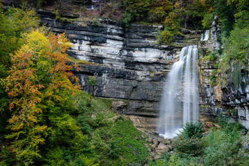 beautiful fall forest landscape with idyllic waterfall