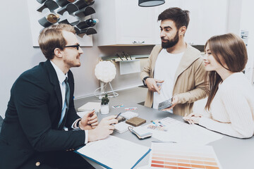 Buyers discuss the colors of kitchen materials.
