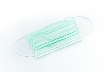 Surgical mask isolated on white background.Concept : Medical waste disposal during the novel COVID-19 pandemic.