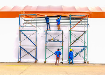 Technician install tensile fabric structure