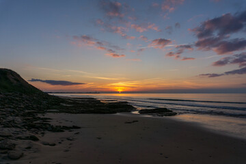 sunset on the Atlantic coast of France on the Ile de with the Baleines Lighthouse behind
