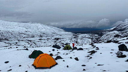 Camp with tents in the snowy mountainous central Kamchatka.