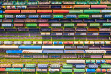 Freight trains made up of multi-colored wagons, aerial view.