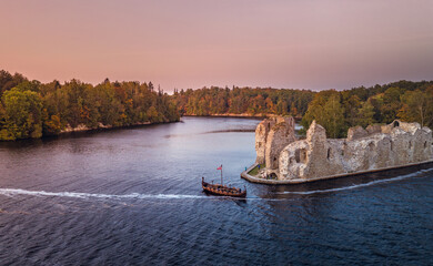 Aerial view of Koknese castle ruins at colorful sunset. Medieval ruins on the shore of river...