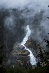 Krimml waterfall during misty foggy morning in the autumn