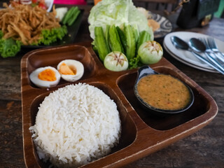Thai food that is called  Chili Paste Rice with Boiled Egg that is placed on a plate ready to eat