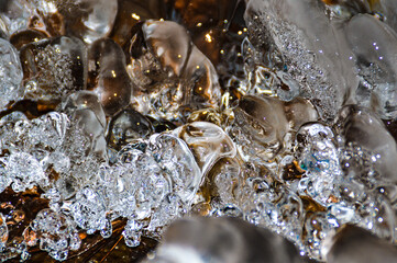Full frame of freezing water in a spring during the winter time