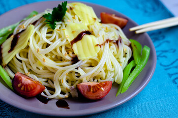 spaghetti with cheese and tomatoes on a plate