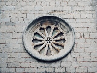 
Vintage round window on grey brick wall