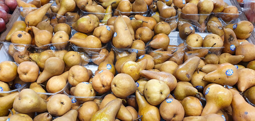 Group of fresh Brown pears available for sale  in a clear boxs displayed at the market