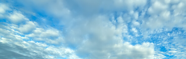 Blue sky background with fluffy clouds