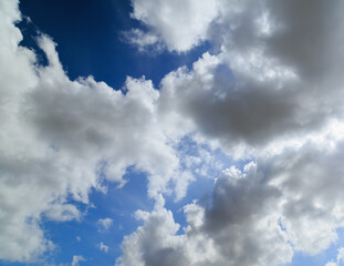 Blue sky background with fluffy clouds