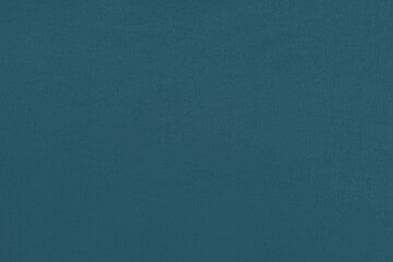 Blue green homogeneous background with a textured surface, fabric.