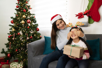 Obraz na płótnie Canvas Little girl getting a surprise Christmas gift