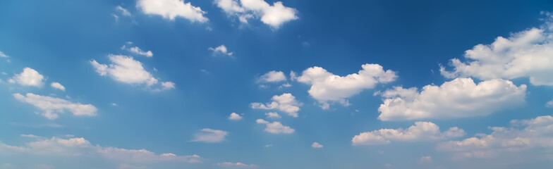 Blue sky background with fluffy clouds