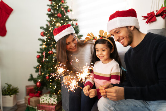 Hispanic Family Lighting Sparklers At Home