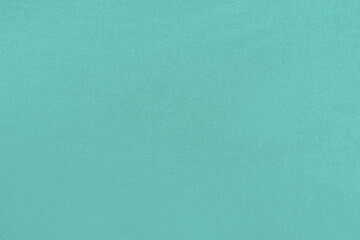 Turquoise homogeneous background with a textured surface, fabric.
