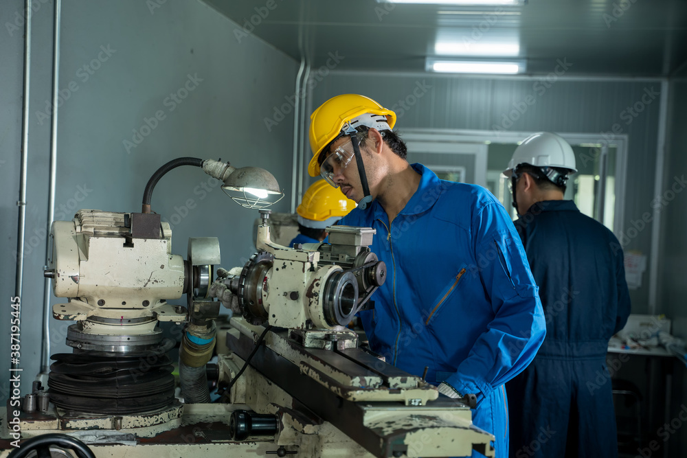 Poster mechanic working in the factory,the industrial worker team is working at a industrial factory.