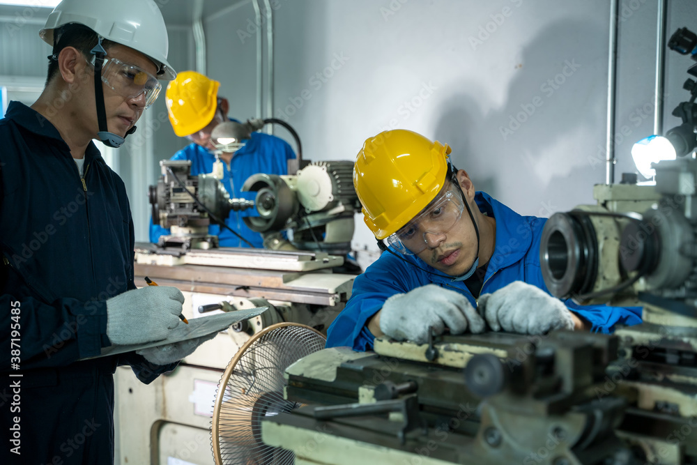 Poster mechanic working in the factory,the industrial worker team is working at a industrial factory.