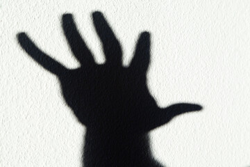 Shadow of a hand against white background