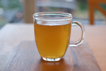 Organic Lemon Green tea in  Transparent cup at table near window