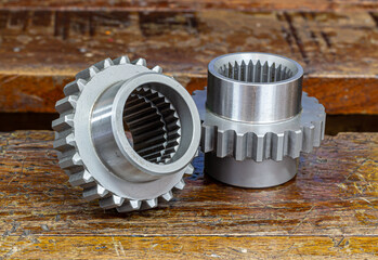 A picture of a metal gear on a wooden floor