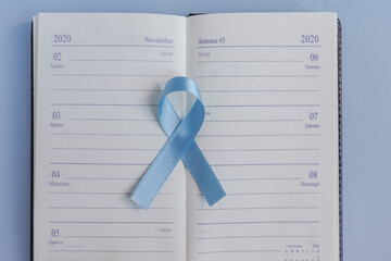 November calendar with a blue ribbon for prostate cancer awareness. Men healthcare concept.