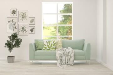 Naklejka premium White living room with sofa and summer landscape in window. Scandinavian interior design. 3D illustration