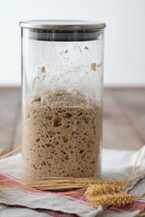 Active rye sourdough starter in a jar. Copy space.