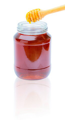 Honey dripping from a honey dipper in a glass cup