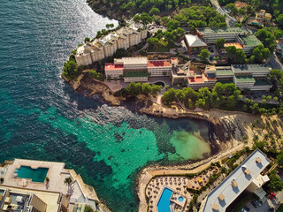 Aerial view green transparent water bay of Mediterranean Sea nd luxury coastal villas. Majorca,...