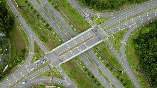 Aerial drone view of highway multi-level junction road with moving vehicles
