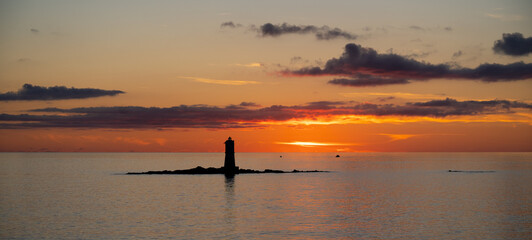 the lighthouse of the Mangiabarche on a serene sunset,autumn day
