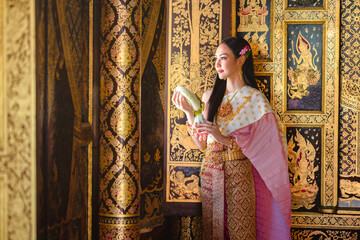 Luxury portrait of a beautiful Thai girl in traditional thai costume, identity culture of Thailand,...
