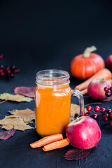 Halloween cocktail, pumpkin orange drink with spices. Dark vintage dirty background. Creative atmospheric decoration