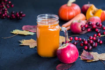 Halloween cocktail, pumpkin orange drink with spices. Dark vintage dirty background. Creative atmospheric decoration