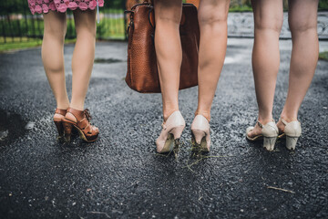 Woman legs. Shoes on dirty hills. Mud on shoes.
