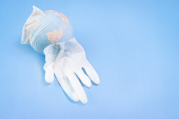 Globe inside a latex glove. Virus protection concept. Environmental pollution concept.