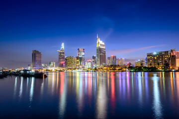 View of Hochiminh city at night from the banks of the Saigon River. Ho Chi Minh City, Vietnam.