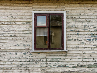 walls and window of an old abandoned village wooden house in Ukraine