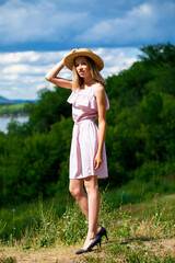 Young beautiful brunette woman in beige dress, summer park outdoor