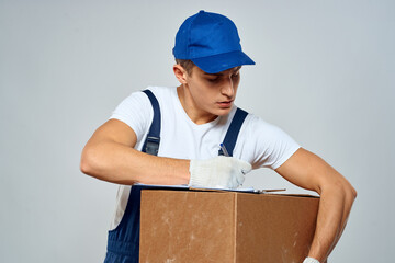 Man worker with box in hands delivery loading service packing service