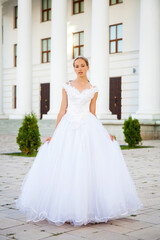 Fototapeta premium Portrait of a young woman in a white ball gown