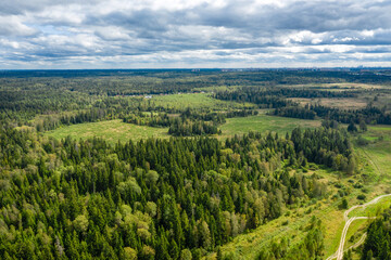 Aerial view of a country road through fields and woods